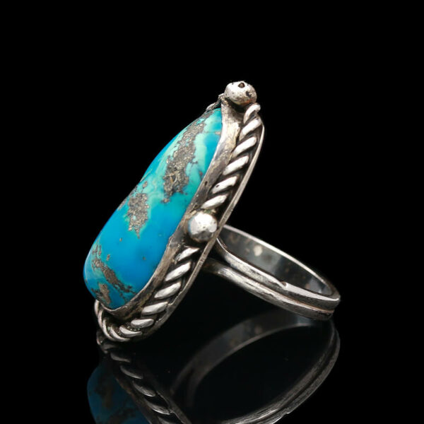 a ring with a turquoise stone in it