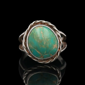 a ring with a turquoise stone in the center
