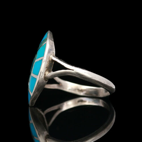 a silver ring with a turquoise stone in it