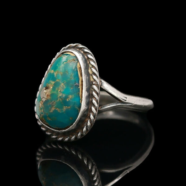a ring with a turquoise stone in it