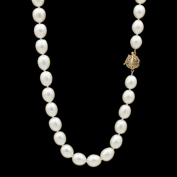 a white pearl necklace with a gold clasp