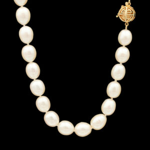 a necklace with pearls and a gold clasp