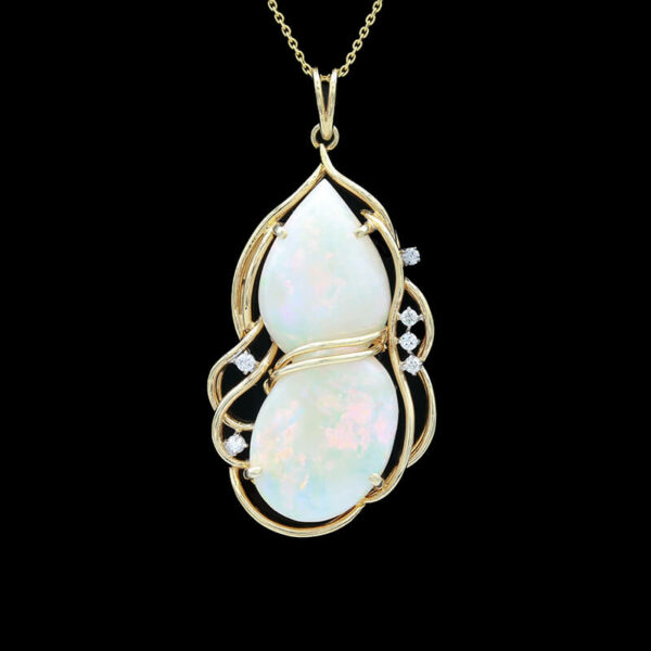 an opal and diamond pendant on a chain