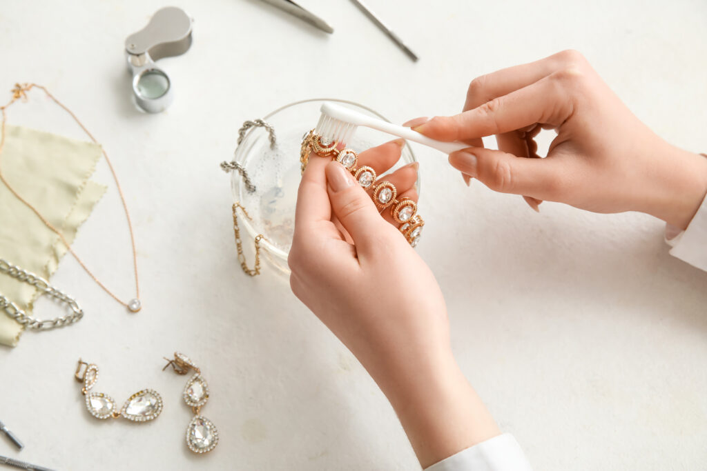 a woman is working on some jewelry