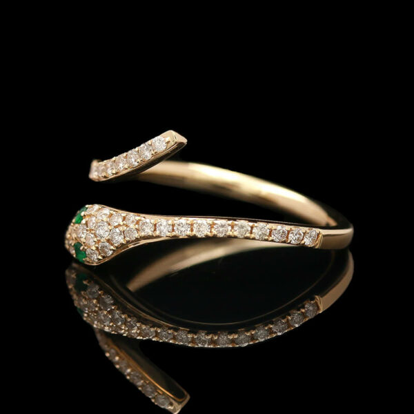 a gold ring with diamonds and emeralds
