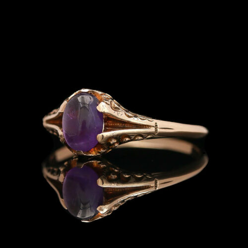 an antique ring with two oval cut amethysts