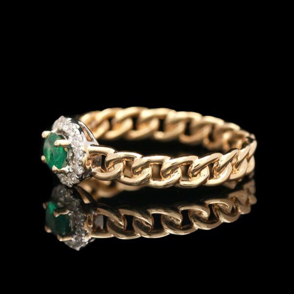 a gold ring with an emerald and diamond