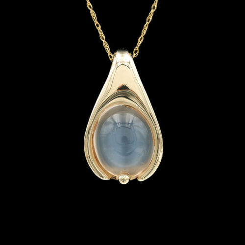 a gold pendant with a blue stone in the center