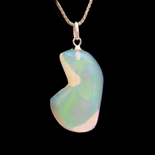 a white and green pendant with a chain