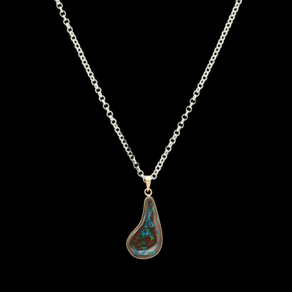a silver necklace with a blue and green pendant