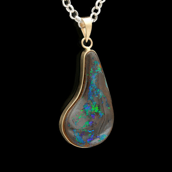a pendant with an opal stone in the center