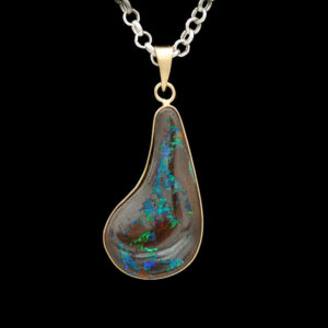 an opalite pendant hangs from a chain