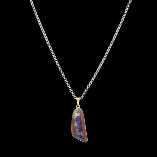 a necklace with a pendant that has an oplite stone in it