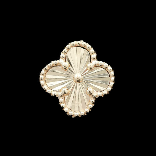 a gold brooch with pearls on it