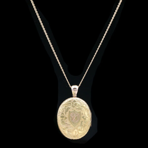 a pendant with a gold medallion on it