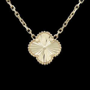 a gold necklace with a flower on it