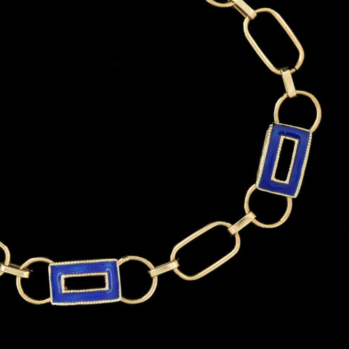 a gold and blue link bracelet on a black background