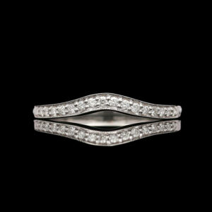 a white gold diamond ring on a black background