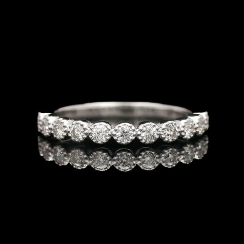 a diamond wedding ring on a black background