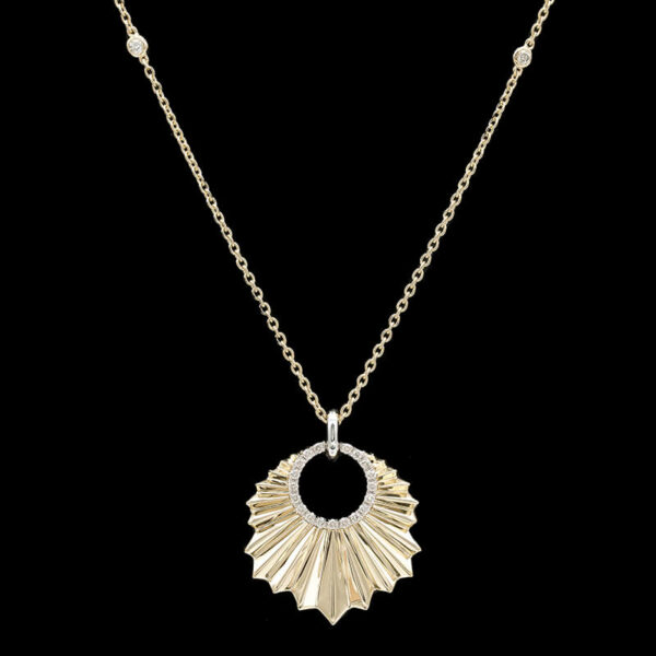 a gold necklace with a circular design on it