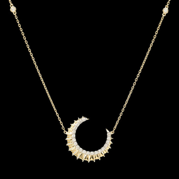 a gold necklace with white stones on it