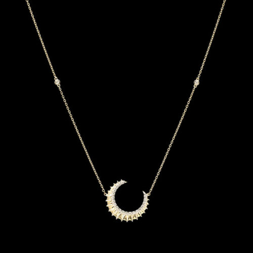 a gold necklace with a crescent shaped pendant