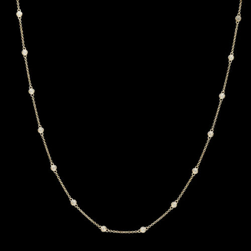 a gold necklace with white pearls