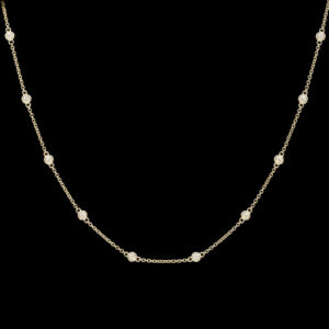 a gold necklace with white diamonds