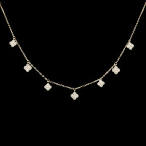 a gold necklace with four diamonds on it