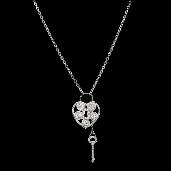 a necklace with a heart and key on it