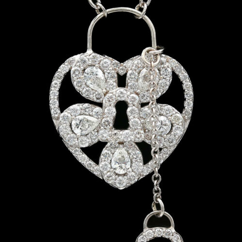 a heart shaped pendant with two hearts attached to it