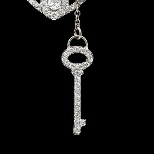 a diamond key is hanging from a chain