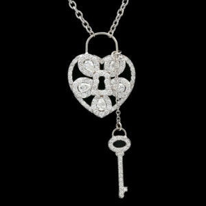 a necklace with a heart shaped key hanging from it