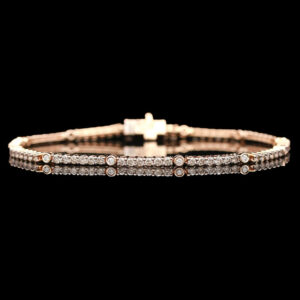 a gold bracelet with white stones and a cross