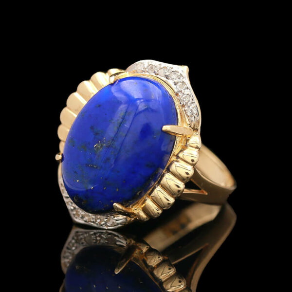 a gold ring with a blue stone surrounded by diamonds