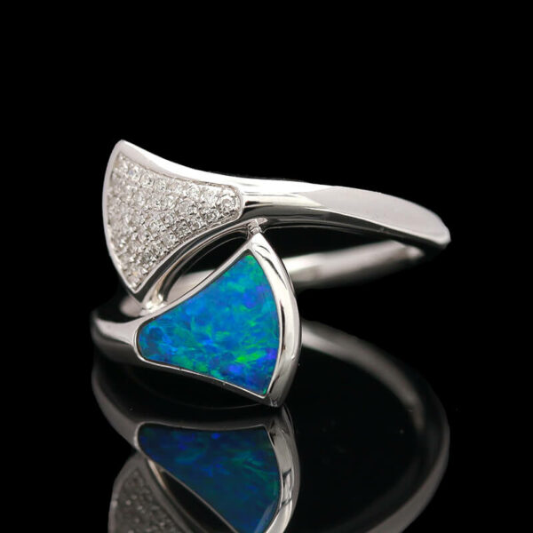 a white gold ring with an opal and diamonds