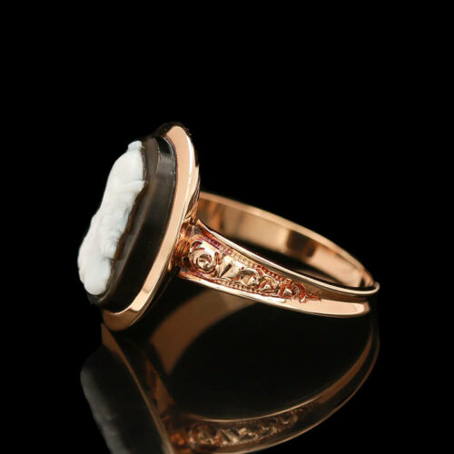 a gold ring with a white stone in the center