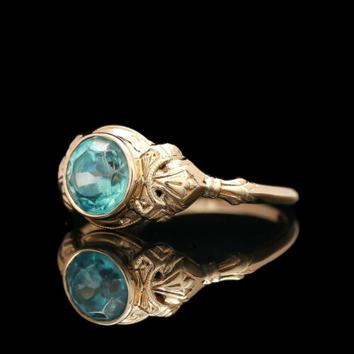 an antique gold ring with blue topaz