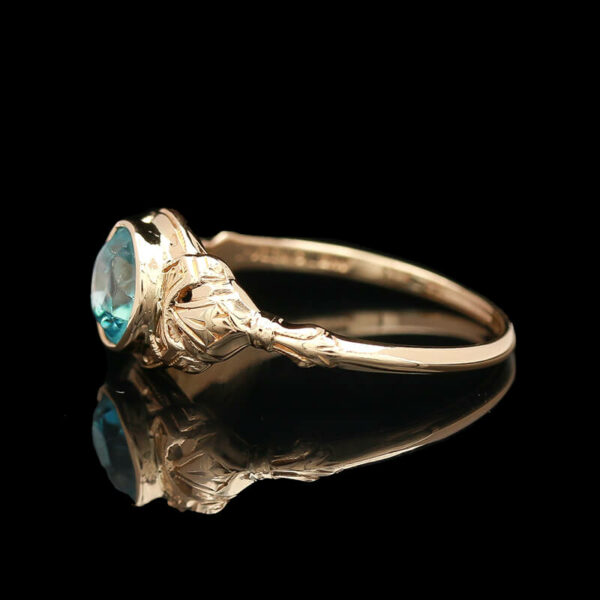 an antique ring with a blue stone in the center