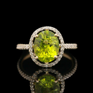 a yellow diamond ring with diamonds around it
