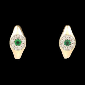 a pair of gold earrings with green and white stones