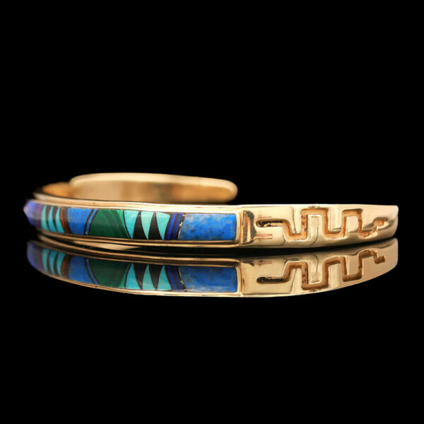 two gold bracelets with blue and green designs