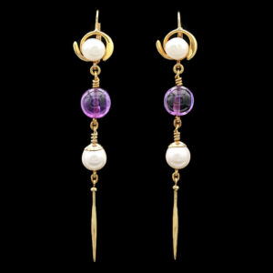 a pair of earrings with dangling pearls and beads