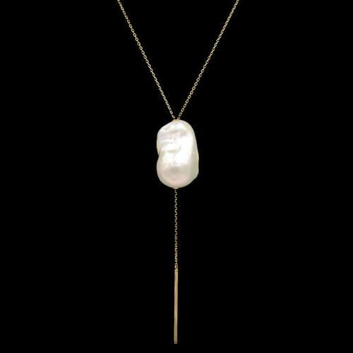 a long necklace with a white shell hanging from it