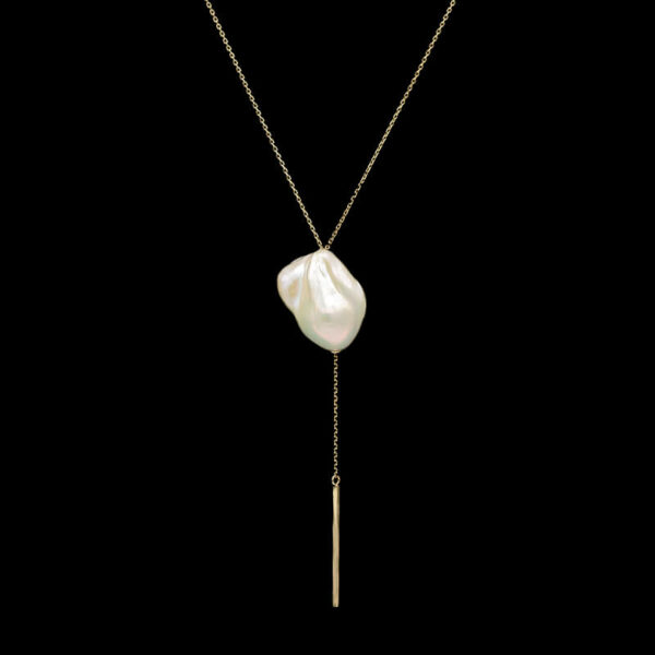 a necklace with a long chain and a white pearl