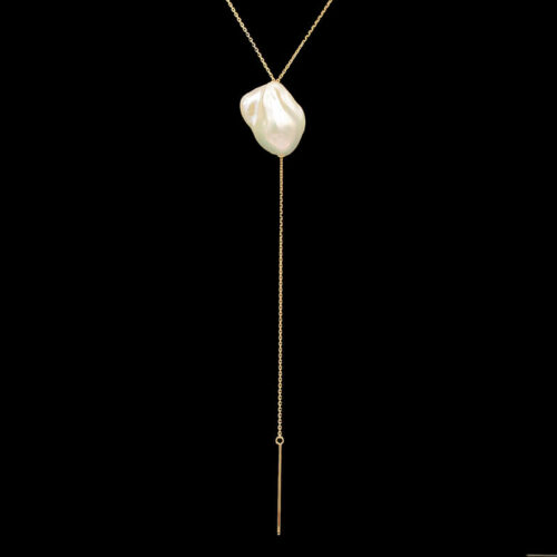 a long necklace with a white pearl hanging from it