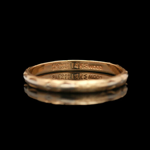 a close up of a gold ring on a black background