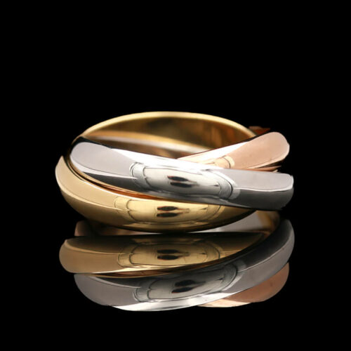 two gold and silver rings on a reflective surface