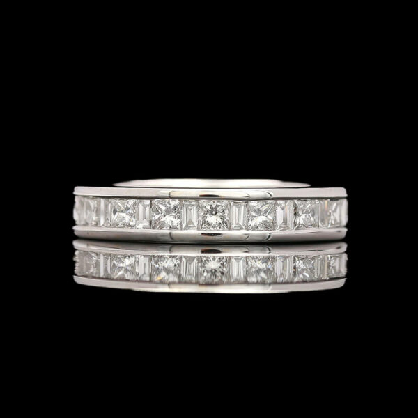 a white gold ring with princess cut diamonds
