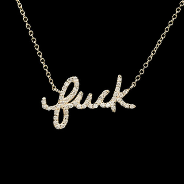 a gold necklace with the word luck written on it